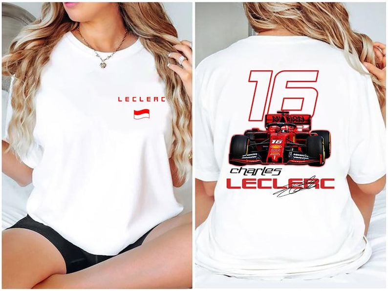 May include: White t-shirt with a red and white flag and the text "Leclerc" on the front. The back of the shirt has a red race car with the number "16" and the text "Charles Leclerc" in red.