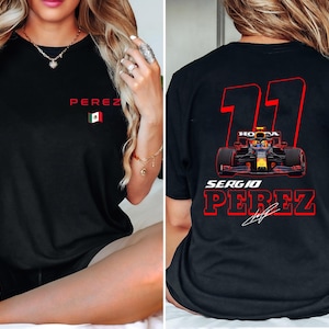 May include: Black t-shirt with a red number "11" and the text "Sergio Perez" in red. The number is outlined in white. A small image of a race car is in the center of the number. The Mexican flag is embroidered on the left side of the shirt.