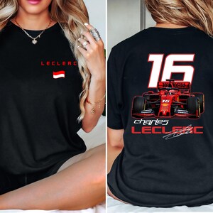 May include: Black t-shirt with a red and white race car graphic and the text "Charles Leclerc" and "16".
