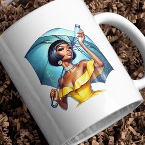 May include: White ceramic mug featuring a colourful illustration of a woman holding an umbrella and a bottle. The woman is wearing a yellow dress and has black hair. The umbrella is blue and has a white handle.