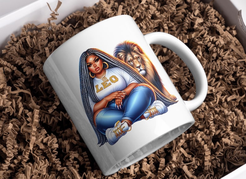 May include: White ceramic mug with a vibrant illustration of a woman with long braids, wearing a white t-shirt with "LEO" in gold lettering, and blue jeans. A lion is behind her. The mug is in a box with brown packing material.