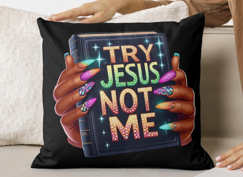 May include: Black throw pillow with a colorful graphic of a hand holding a book with the text "TRY JESUS NOT ME" in sparkly letters.