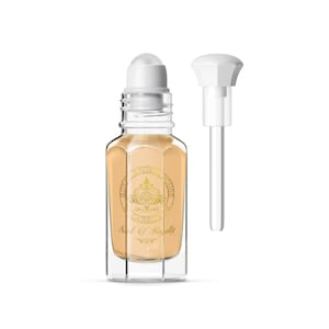May include: A clear glass perfume bottle with a white rollerball top and a separate white pump. The bottle contains a light beige liquid and features gold lettering and a crest. The text on the bottle reads "ROYAL AROMA HOUSE CANADA" and "Scent Of Royalty".