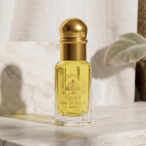 May include: A perfume bottle with a gold-coloured cap and collar, filled with a yellow liquid. The bottle has a clear, rectangular base and a label with the text "Royal Aromatique Canada" and "Scent Of Royalty."