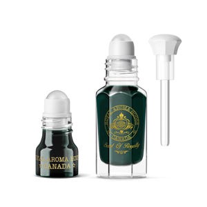 May include: Two glass perfume bottles with white caps and dark green liquid. One bottle has a rollerball applicator, the other has a dropper. The bottles have gold text that reads "Royal Aroma House Canada" and "Scent of Royalty".