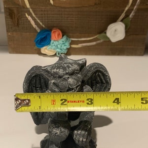 May include: A gray stone gargoyle statue with wings, sitting on a base. The statue is 3 inches tall.