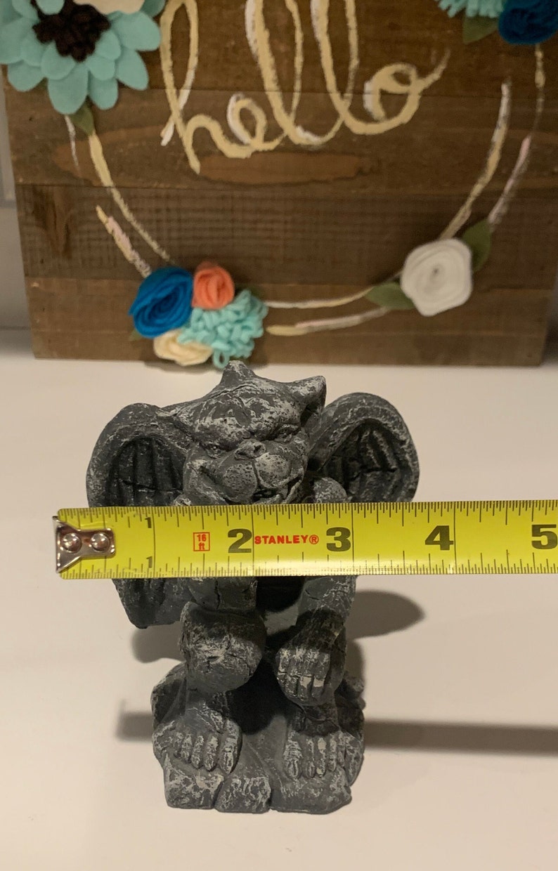 May include: A gray stone gargoyle statue with wings, sitting on a base. The statue is 3 inches tall.