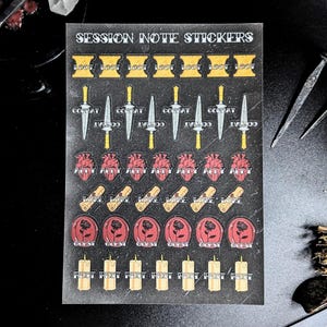 May include: A sheet of stickers with various designs, including swords, hearts, scrolls, roses, and candles. The stickers have text that reads "LOOT", "COMBAT", "ALLY", "LORE", and "REST". The sheet is labeled "SESSION NOTE STICKERS".