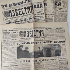 May include: A collection of vintage newspapers with Cyrillic text, featuring headlines like "Izvestia" and "Trud". The papers are aged with visible wear and tear, showcasing historical content and imagery.