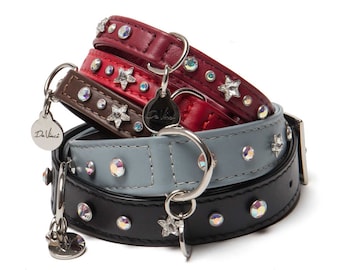 May include: A stack of four leather dog collars with star-shaped embellishments and rhinestones. The collars are in black, gray, brown, and red.