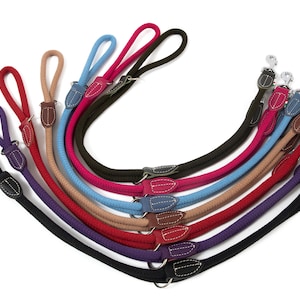 May include: A set of eight dog leashes in various colors, including black, navy, purple, red, beige, blue, green, and pink. Each leash has a leather handle and a silver metal clip.