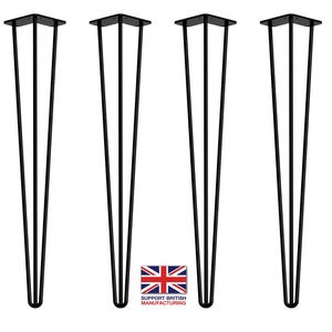 May include: Four black metal hairpin legs for furniture. Each leg has three prongs and is approximately 40 cm tall.
