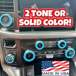 May include: A car interior with a dashboard featuring several round knobs with blue and silver accents. The knobs are labeled with text such as "PRO TRAILER", "VOL", "TUNE", and "DRIVE MODE". The text "2 TONE OR SOLID COLOR!" is displayed on the screen. The text "MADE IN USA" is displayed at the bottom of the image.