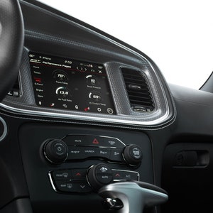 May include: A black car interior with a digital display showing performance data, including engine temperature, air fuel ratio, and coolant temperature. The display is labeled "Performance Pages".