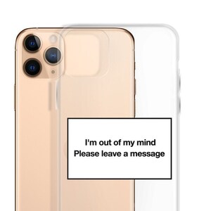 May include: A gold iPhone case with a clear back and a white sticker that says "I'm out of my mind. Please leave a message."