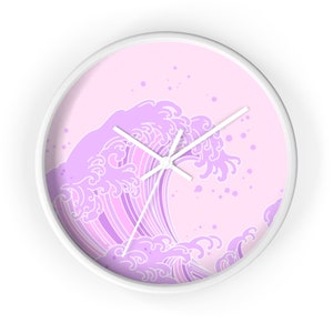 May include: A white wall clock with a pink background and a purple wave design. The wave is stylized and has a Japanese aesthetic.