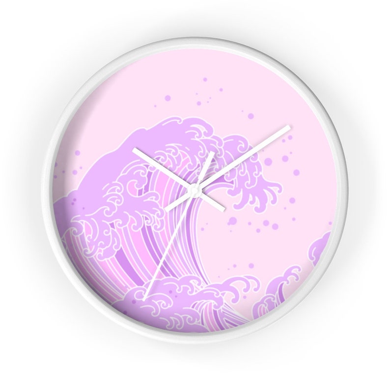 May include: A white wall clock with a pink background and a purple wave design. The wave is stylized and has a Japanese aesthetic.
