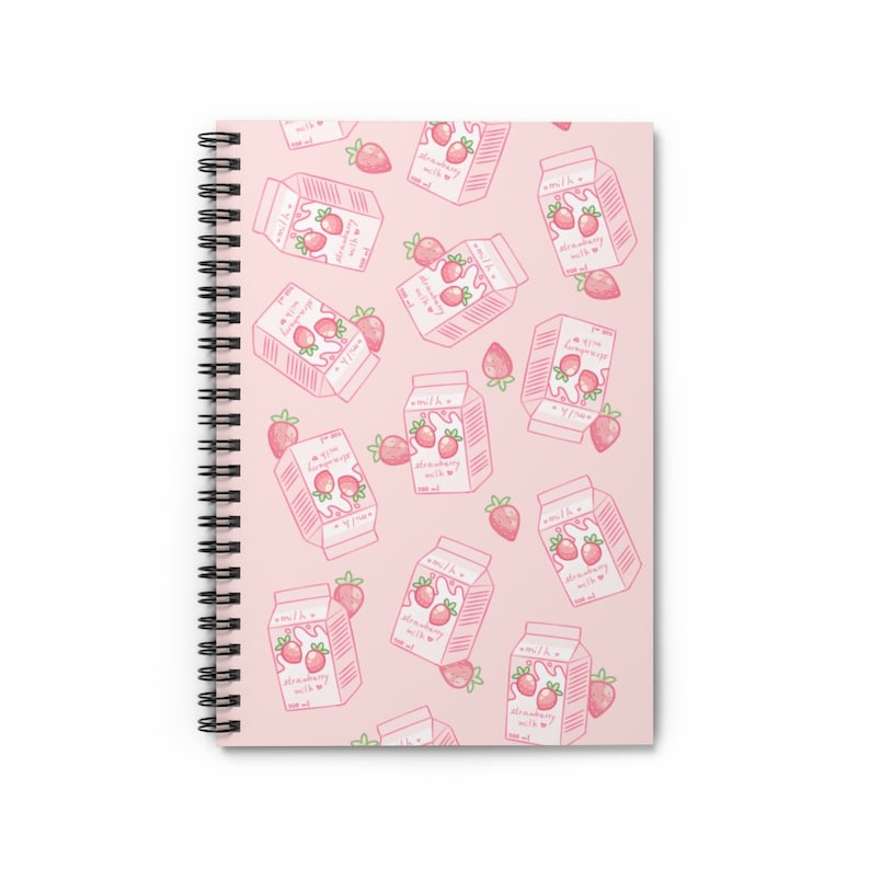 May include: Pink spiral notebook with a pattern of strawberry milk cartons and strawberries. The cartons are white with pink lids and say "100 ml Strawberry Milk".
