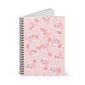 May include: Pink spiral notebook with a repeating pattern of pink milk cartons with a strawberry design and the text "milk with strawberry" on them.