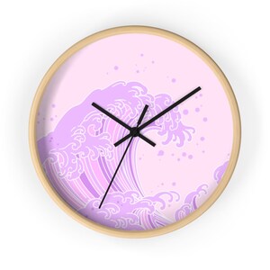 May include: A pink and white wave design wall clock with black hands.