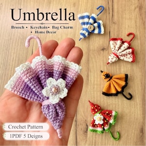 May include: Five miniature crochet umbrellas in various colors including purple, blue, red, and orange. The umbrellas feature decorative elements like small buttons and flowers. Text on the image reads Umbrella, Brooch, Keychain, Bag Charm, Home Decor, Crochet Pattern, 1PDF 5 Designs.