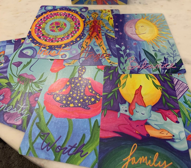 May include: Set of ten colorful cards with illustrations and text. The cards feature words like "Trust", "Balance", "Worth", and "Family".