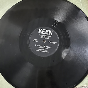 May include: Black vinyl record with white text. The text reads "KEEN", "REX PRODUCTIONS, INC.", "8479 Higuera St.", "Culver City, Calif.", "4-4013", "(9-57129)", "Gershwin-ASCAP", "Time 2:24", "SUMMERTIME", "(Gershwin-Heyward)", "SAM COOKE", "BUMPS BLACKWELL ORCH."