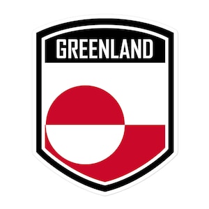 Może przedstawiać: Naklejka w kształcie tarczy w kolorze czerwonym, białym i czarnym z napisem "GREENLAND" w białym kolorze i flagą Grenlandii w środku.