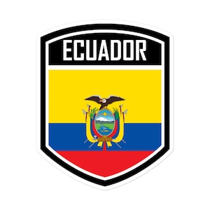 May include: A black and white shield-shaped sticker with the word "ECUADOR" in white letters on a black background. The shield contains the flag of Ecuador, which features a yellow field with the national coat of arms in the center, a blue stripe, and a red stripe.