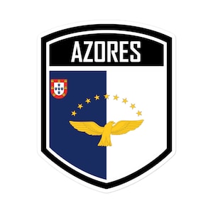 May include: A sticker featuring the Azores flag design. The design includes the word "AZORES" in white block letters above a shield divided vertically into blue and white sections. A golden eagle and stars are featured.