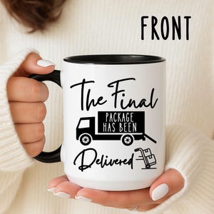 May include: White ceramic mug with a black interior and handle. The mug features the text "The Final Package Has Been Delivered" with a graphic of a delivery truck and hand truck.