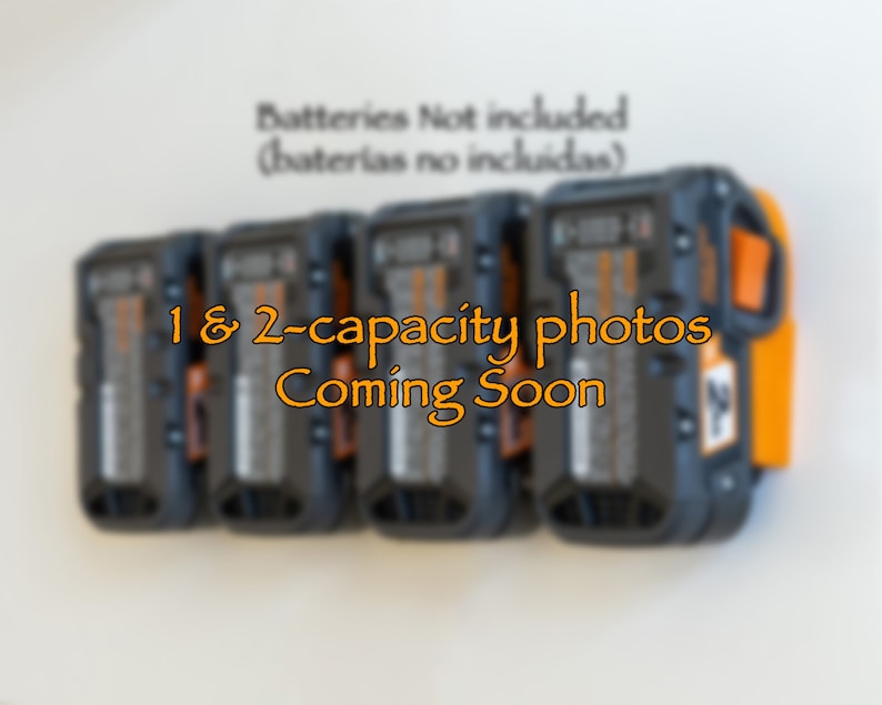 Puede incluir: Soporte de pared para bater&iacute;as de herramientas el&eacute;ctricas, negro y naranja. La imagen muestra varias bater&iacute;as en el soporte. El texto dice "1 & 2-capacity photos Coming Soon" y "Batteries Not included".