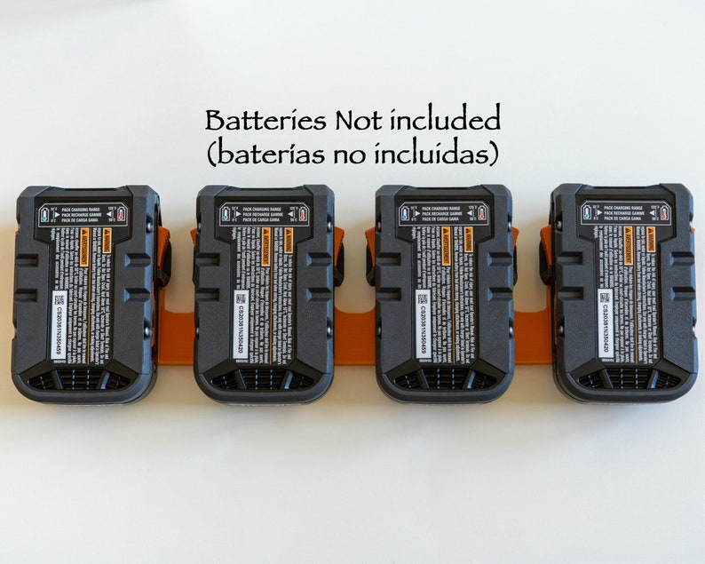 Puede incluir: Cuatro paquetes de bater&iacute;as negros y naranjas montados en un soporte naranja. Cada paquete tiene una etiqueta detallada con texto y un n&uacute;mero de serie. El texto "Batteries Not included" est&aacute; encima de los paquetes.