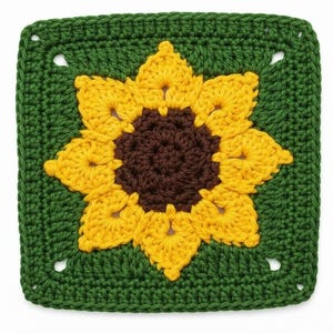 May include: A square, hand-crocheted item with a sunflower motif. The sunflower has a brown centre and yellow petals, set against a green background. The edges are also green, creating a framed effect. Likely a decorative item, perhaps a coaster or part of a larger project.