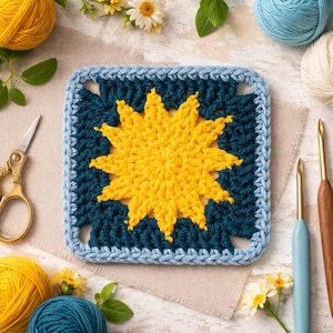 May include: A square, handmade crochet piece featuring a yellow sunburst design on a teal background, framed by a light blue border. The image includes yarn balls, crochet hooks, and scissors, suggesting a crafting theme.