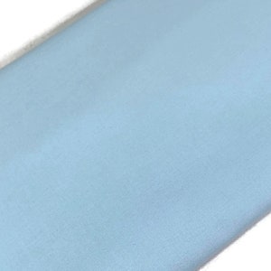 May include: A solid light blue fabric swatch. The fabric has a smooth, slightly textured surface.
