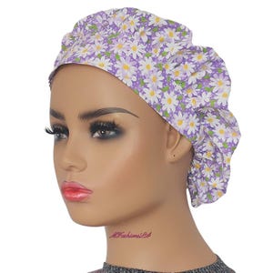 a mannequin head wearing a purple and white flowered turban