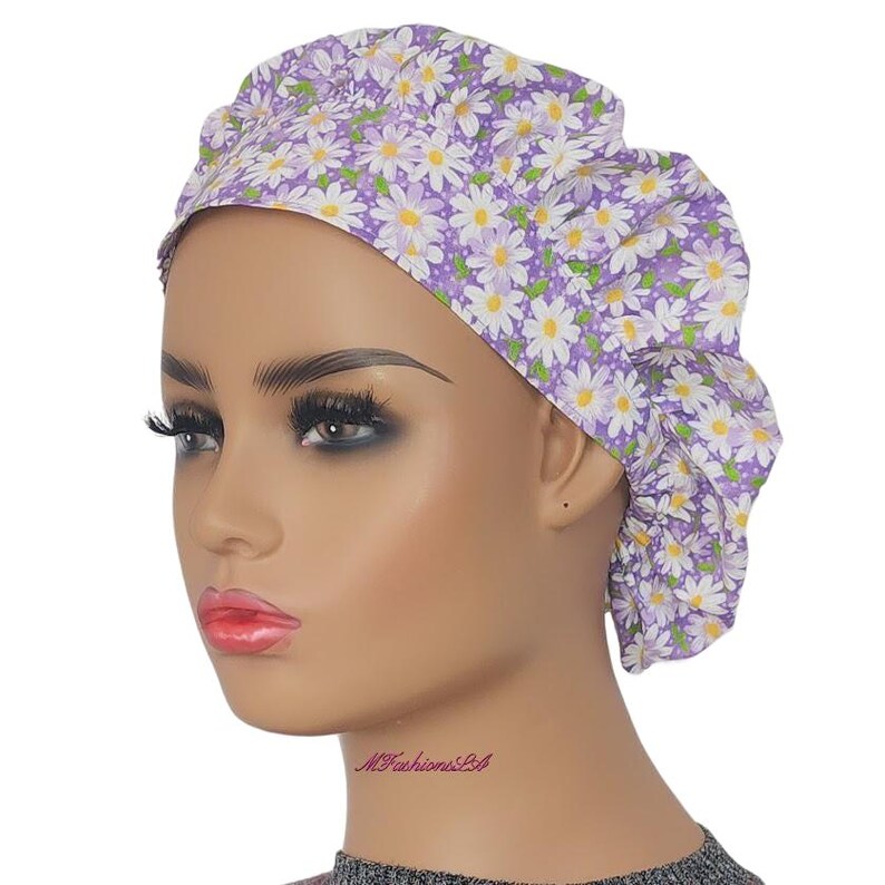 a mannequin head wearing a purple and white flowered turban