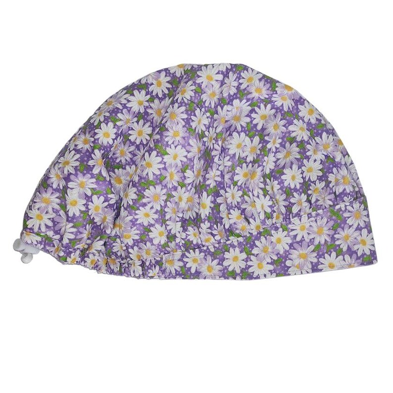 a purple and white hat with daisies on it