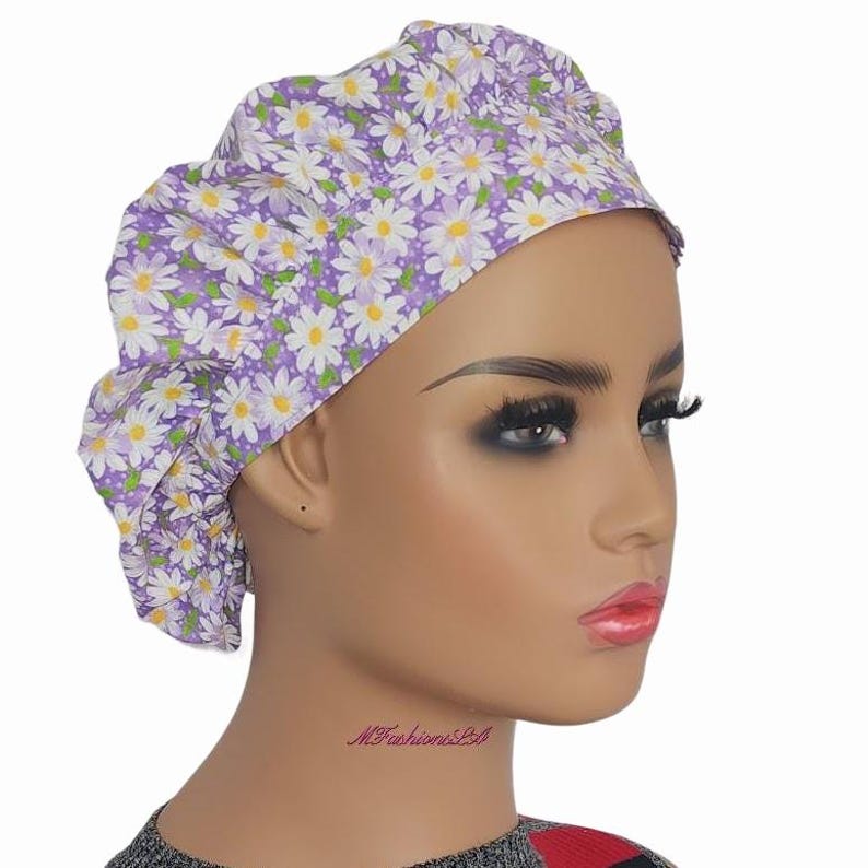 a mannequin head wearing a head wrap with flowers on it