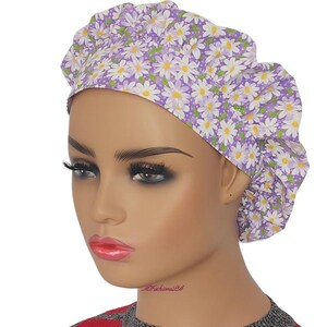a mannequin head wearing a purple and white flowered turban