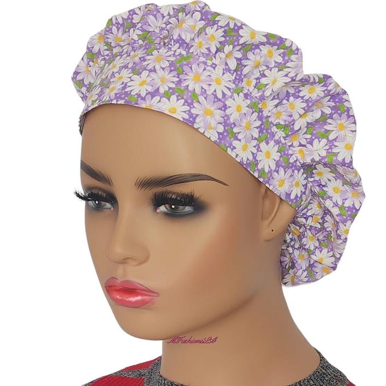 a mannequin head wearing a purple and white flowered turban