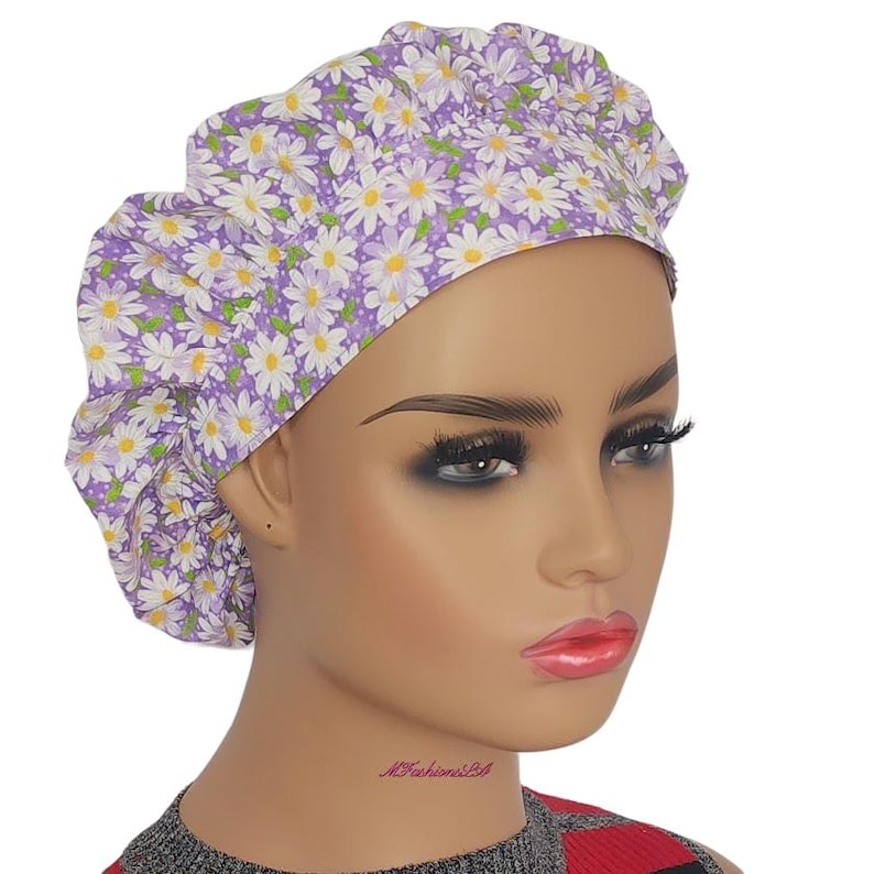 a mannequin head wearing a purple and white flower turban