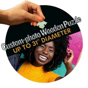 May include: A round wooden puzzle with a photo of a smiling woman with curly hair. The puzzle is up to 31 inches in diameter. The text "Custom-photo Wooden Puzzle UP TO 31" DIAMETER" is printed on the puzzle.