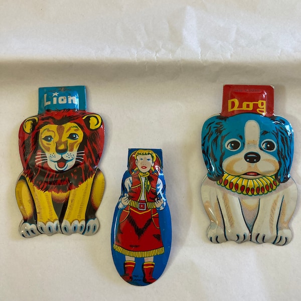 Vintage tin clickers with great graphics! Lion, Dog and Cowgirl!