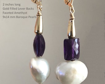 May include: A pair of gold-filled lever back earrings with a faceted amethyst gemstone and a 9x14 mm baroque pearl. The earrings are 2 inches long.