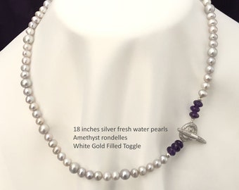 May include: An 18 inch silver freshwater pearl necklace with amethyst rondelles and a white gold filled toggle clasp.