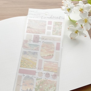 May include: A clear plastic sheet of landscape-themed stickers. The stickers feature pastel-colored images of fields, skies, and flowers, along with rectangular and circular shapes. The word "Landscape" is written on the sheet.