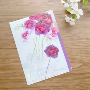 May include: A clear plastic folder with a floral design featuring pink and purple roses. The folder has a purple border and the text "Modern Flowers" is printed on the bottom right corner.
