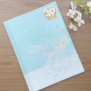 May include: A light blue plastic folder with a 3D Cinnamoroll character design. The folder has a gold sticker that says "3D" and "Clear File".